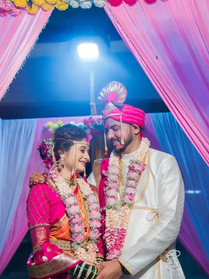 An intimate portrait of the couple under the wedding mandap, their faces close in a moment of love.