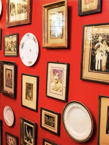 With an unwavering passion for storytelling through design, I have filled my space with treasures like this wall of vintage portraits and plates.