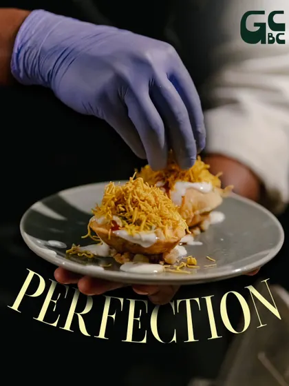 A final sprinkle of sev on our Dahi Puri. It's all about perfection.
