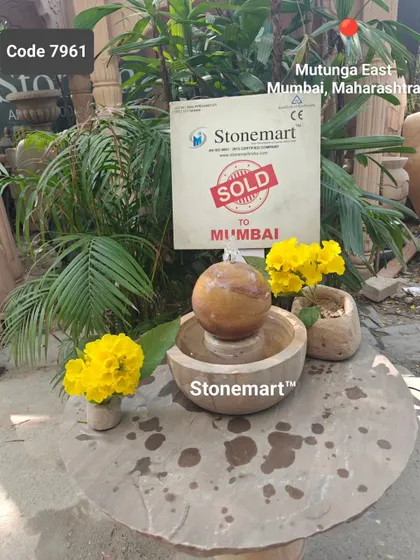 The small sphere fountain, sold to Mumbai, is shown here with decorative flowers.