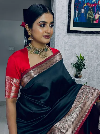 This is one of my favorite classic looks for a photoshoot. I created a defined, smoky eye and a bold lip to complement the beautiful black and red silk saree, ensuring the makeup was flawless and camera-ready under studio lights.