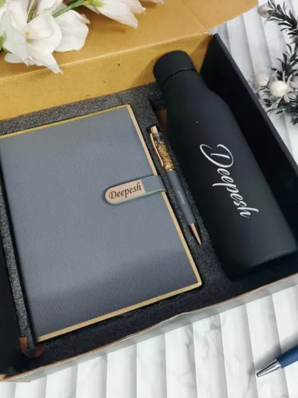 A stylish grey diary and black temperature bottle gift set. Both items are personalized with a name, making it a practical and thoughtful present.