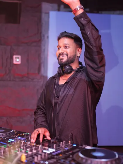 Hand in the air, feeling the beat. I don't just stand behind the booth; I am an active part of the party's energy.