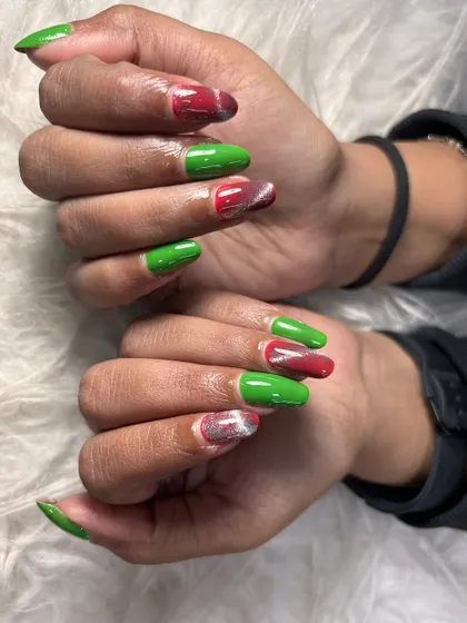 A festive and unique color combination of bright green and red, with a cat-eye effect on the red nails. This is a great example of a creative holiday design.