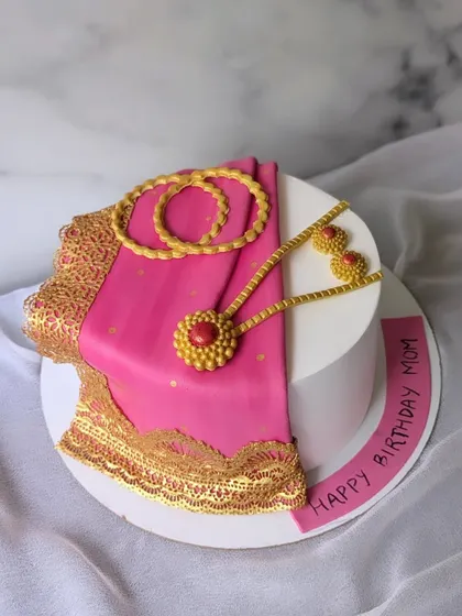 In a world full of trends, a saree is pure elegance. This cake features a beautifully draped pink fondant saree with intricate gold lace details.