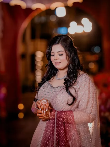 A beautiful solo portrait of the bride-to-be, looking down with a gentle smile.