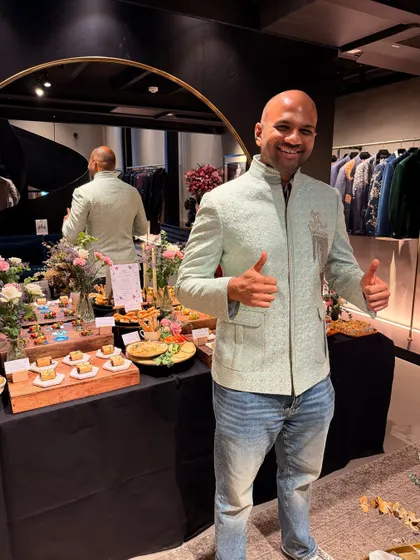My husband trying on a mint green bandhgala jacket at a designer preview. This is a great example of modern Indian menswear that is stylish and perfect for a wedding or festive event.