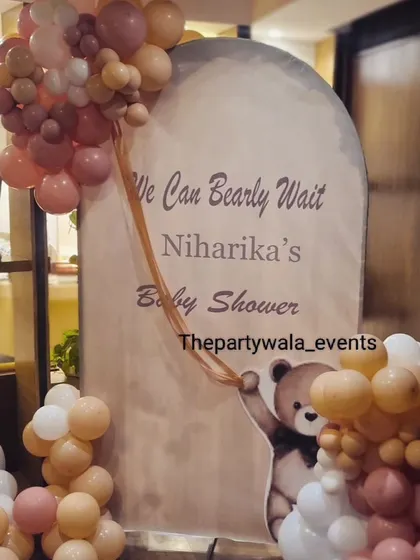 A close-up of the custom "We Can Bearly Wait" backdrop for a teddy bear themed baby shower.