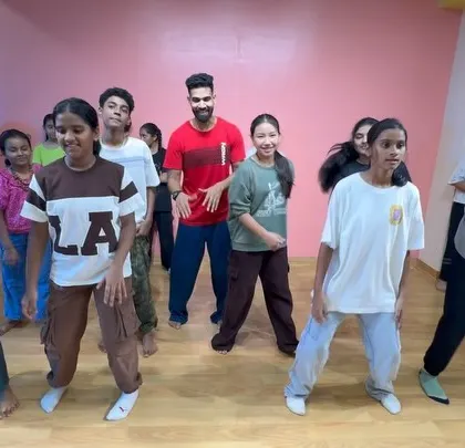 A candid shot of the kids learning a new routine during our dance workshop.