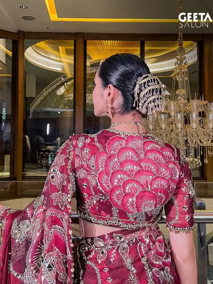 A detailed shot of the intricate hair accessory and the clean lines of the bun, a perfect example of traditional elegance.