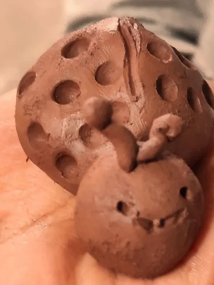 Tiny hands working hard to create a cute ladybug. These small projects are perfect for developing fine motor skills and learning basic sculpting techniques in a fun way.