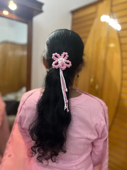 A beautiful customer wearing my pink and white macrame flower hair tie. It looks so lovely in her ponytail.