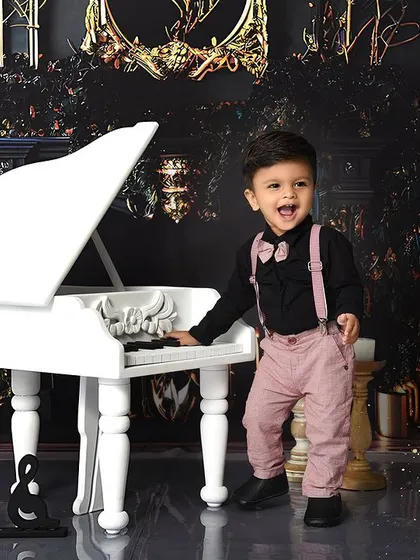 Dressed to impress for his piano recital. This theme is perfect for capturing a more formal and dapper look, complete with a bow tie and suspenders.