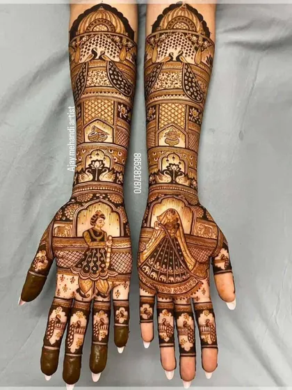 This design is a masterpiece of symmetry and detail. It features bride figurines in a doli, surrounded by peacocks, paisleys, and delicate floral work.
