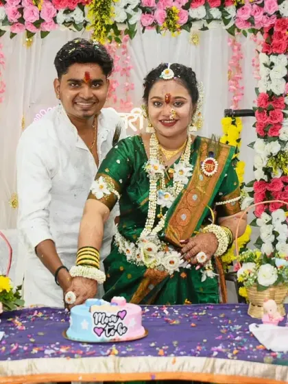 The official cake-cutting moment at a traditional baby shower. The couple is all smiles as they celebrate this sweet part of the ceremony.