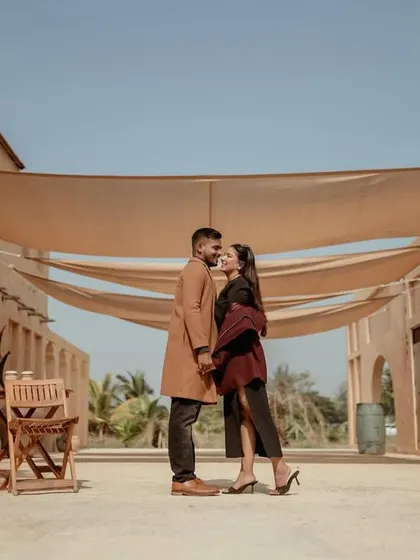 A wide, cinematic shot of the couple in the middle of a desert-themed street.
