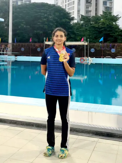 Shrungi Rajesh Bandekar showcases her medals after an incredible performance at the All India University Swimming Games, including two golds in relay events.