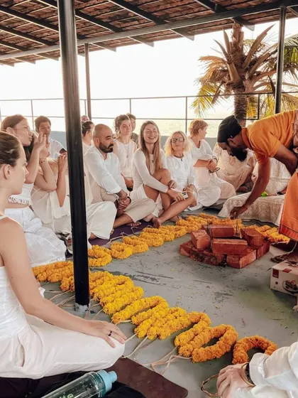 An instructor prepares the sacred space for our Havan ceremony, carefully arranging the elements needed for the ritual.