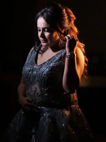 An intimate, low-light portrait of the bride. The soft lighting highlights her features and creates a sense of quiet elegance and contemplation.