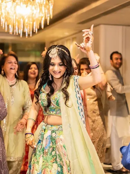 The bride leading the charge on the dance floor with all her family and friends. These are the candid, high-energy moments that make a wedding celebration truly feel alive.