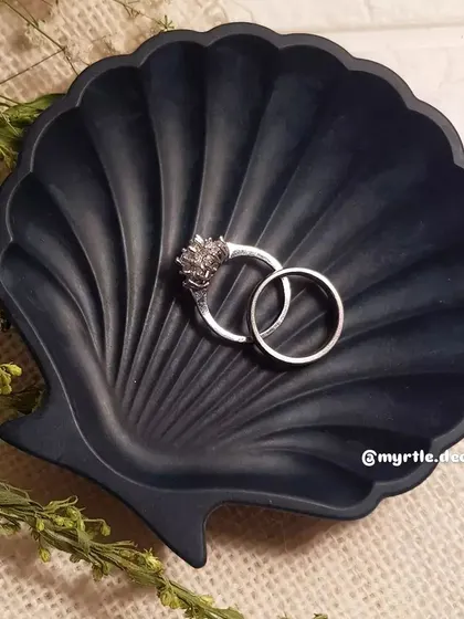 The navy blue mini shell dish is a timeless classic. It’s perfect for holding wedding bands or other precious items.