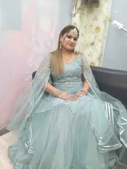 A client looking serene in a powder blue gown with silver work and a cape-style dupatta. A graceful rental choice for an evening function.