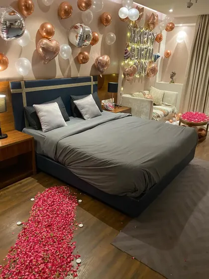 The full room view, showing a path of rose petals leading to the bed, making for a truly grand romantic gesture.