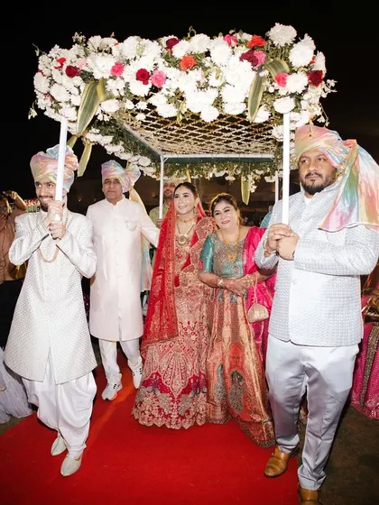 The bride's entry under a beautiful 'phoolon ki chadar' held by her brothers and father. This is always one of the most emotional and beautiful moments of an Indian wedding.