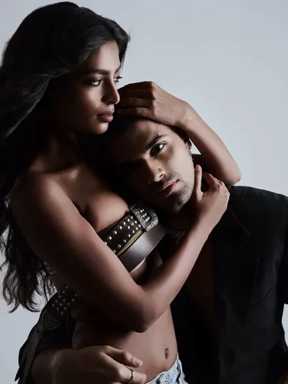 A dark and moody couples portrait, with the lighting creating a sense of intimacy and drama.
