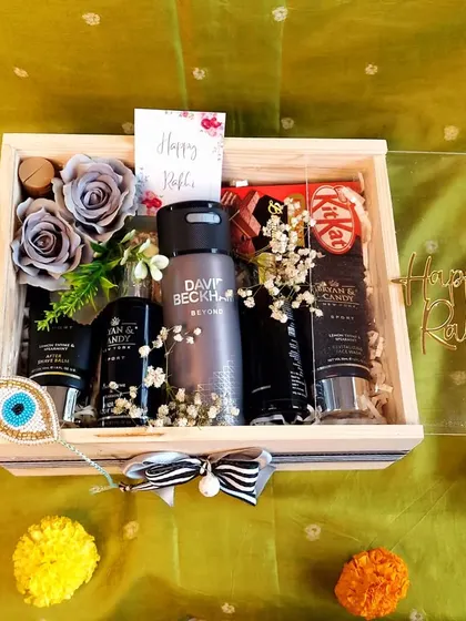 This premium Rakhi hamper for a brother is all about luxury. It includes a David Beckham deodorant, a complete grooming kit, and other high-end treats in a clear-top wooden box.