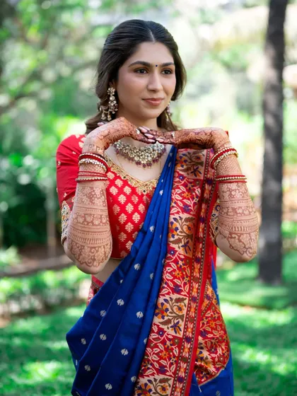 Showcasing her beautiful henna. The makeup is soft and complementary, allowing the traditional elements to shine.