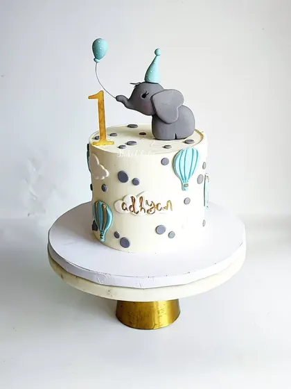 Cuteness alert! A Belgian chocolate cake for an intimate first birthday, featuring a baby elephant with a balloon.
