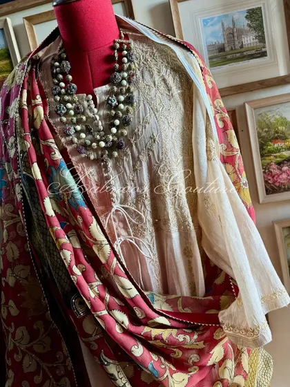 This image captures the graceful fall of the Anarkali and the rich, artistic drape of the Kalamkari dupatta.