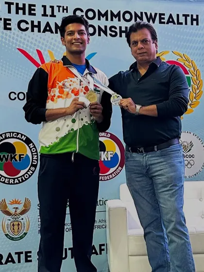 Presenting a medal to my son Pranay at the 11th Commonwealth Karate Championship. A moment of immense pride and joy.