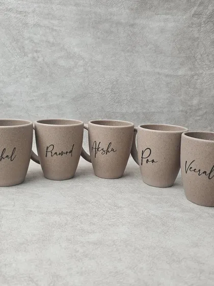 For an eco-conscious choice, I offer these coffee mugs made from bamboo husk. They are durable, lasting up to 3000 washes, and can be personalized with a name in a beautiful script font.