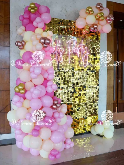 A glamorous photo booth with a "Let's Party" neon sign against a gold sequin wall, framed by pink and gold balloons. This is just one of the many photo opportunities I can create for your event.
