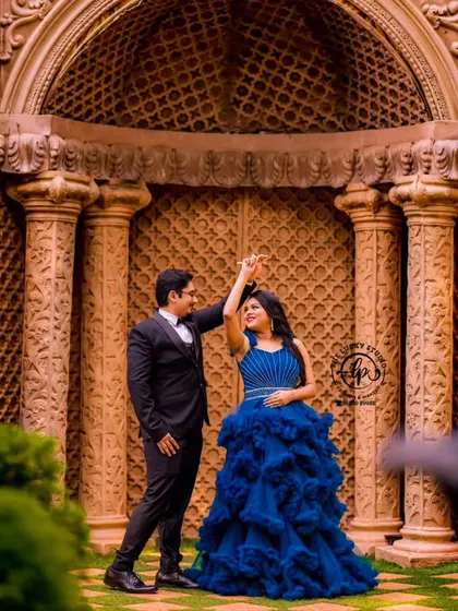 A dance pose showing the beautiful movement of the blue ruffled gown. My service includes helping couples choose outfits that are not only beautiful but also versatile for different types of photos.