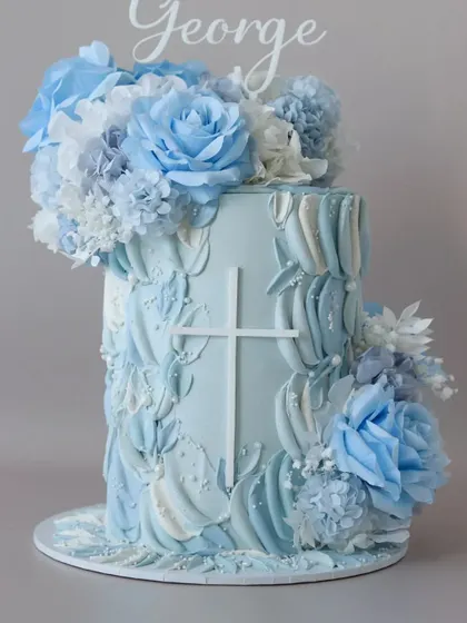 A gorgeous blue and white floral cake with a textured buttercream finish. This design is perfect for a baptism, wedding, or elegant birthday.