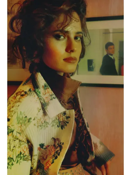 A close-up from "Collision of thens," where the soft focus and warm light create a sense of intimate nostalgia. The reflection in the background hints at a past self or a past love.