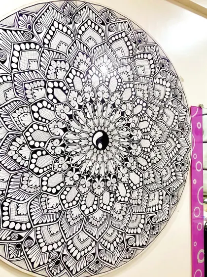 A close up of a 4 foot mandala with a Yin Yang symbol at its center. This piece was designed to bring a sense of balance and harmony to the space.