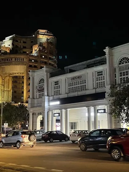 A night view of Connaught Place, showing the Statesman House and Oxford Bookstore. This area, the commercial heart of Lutyens' Delhi, has its own rich 20th-century history.