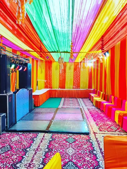 The same tent setup from another angle, showing the colourful seating arrangement and the full length of the venue.