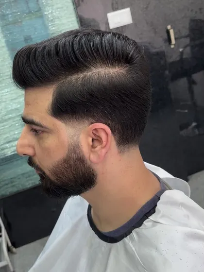 A classic side part hairstyle combined with a low taper fade. This look is timeless, professional, and always sharp.