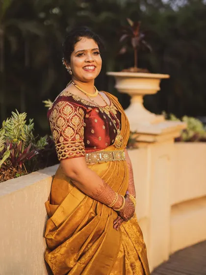 The groom's sister ready for the wedding in a gorgeous gold Kanchipuram saree, which I draped in a modern lehenga style for a unique look.