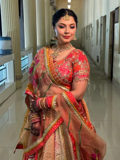 A beautiful portrait of the bride, showcasing the intricate details of her outfit and the flawless, long-lasting makeup.