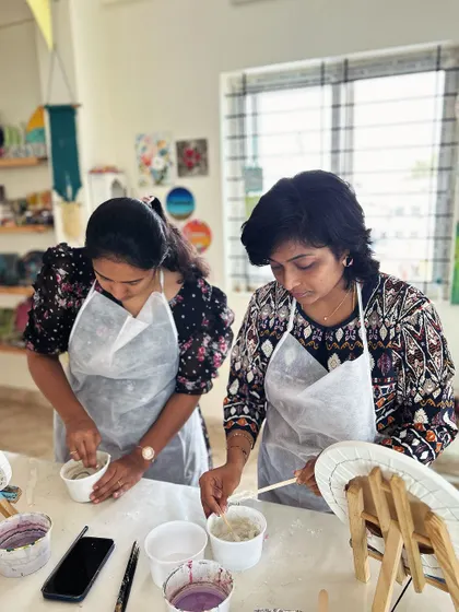 Participants mixing materials at the start of a textured art workshop.