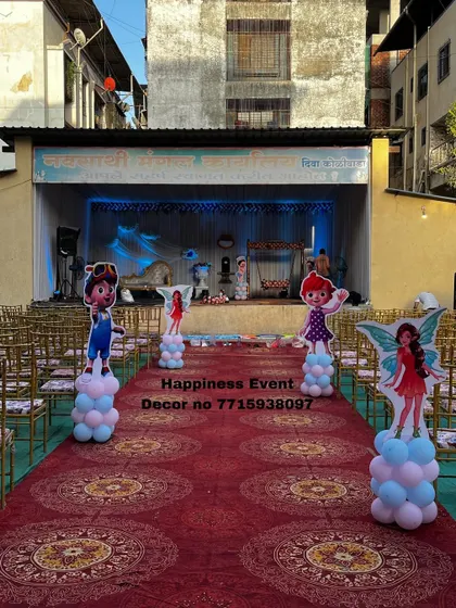 This image shows the full view of a venue decorated for a naming ceremony. I place character cutouts along the aisle to welcome guests and guide them towards the main stage.
