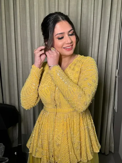Radiant in yellow for Diwali festivities. This look is bright and glowing, with a soft smokey eye and a pretty, textured ponytail.