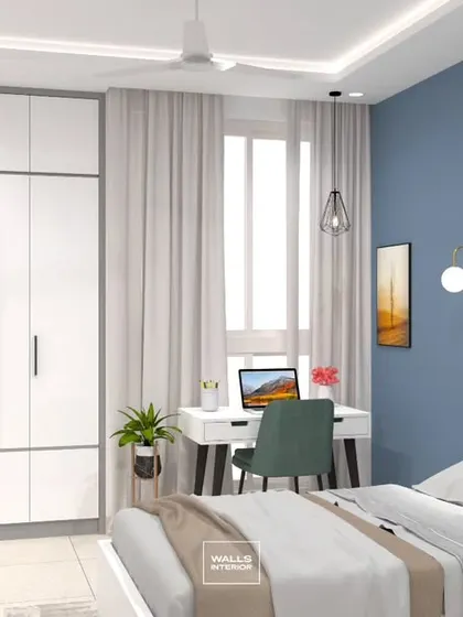 Another perspective of the blue-themed bedroom, showing how the white furniture and light-colored flooring make the room feel bright and spacious.