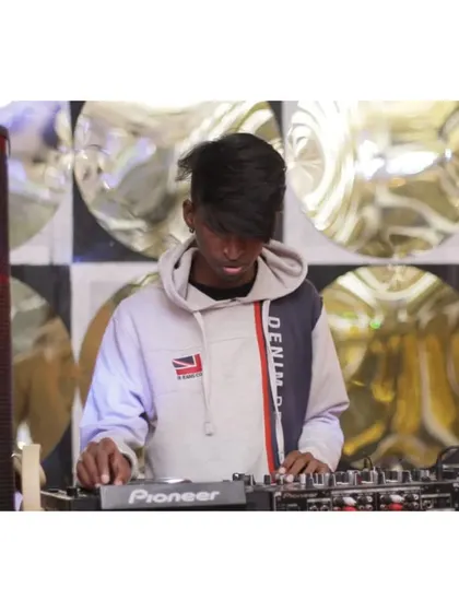 Another shot from the same set, focused on the hands-on work of a DJ.
